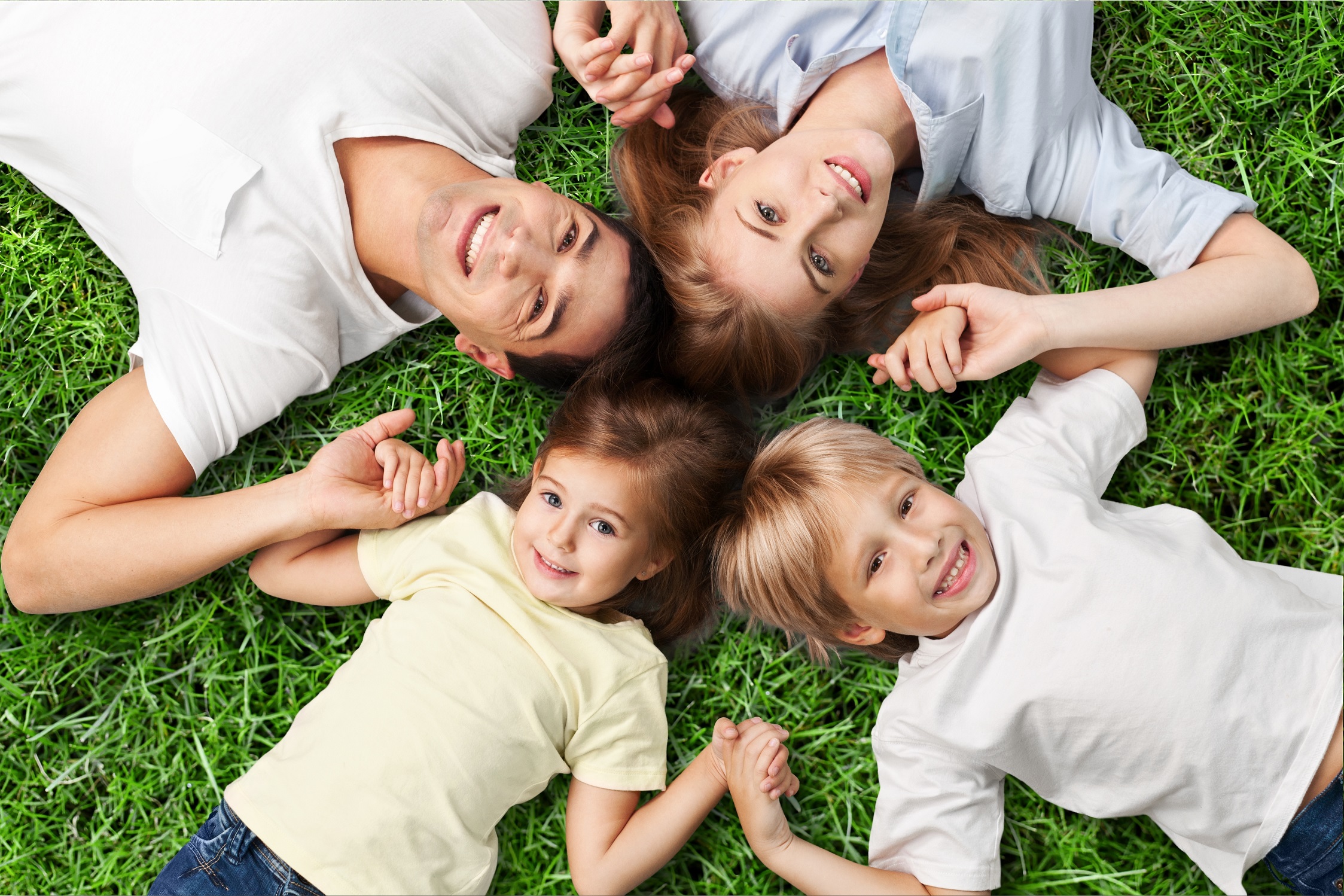 Portrait of happy family lying on floor in their new house